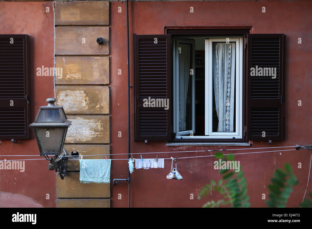 Linen and shoes drying outside the window in the Trastevere district in Rome, Italy. Stock Photo