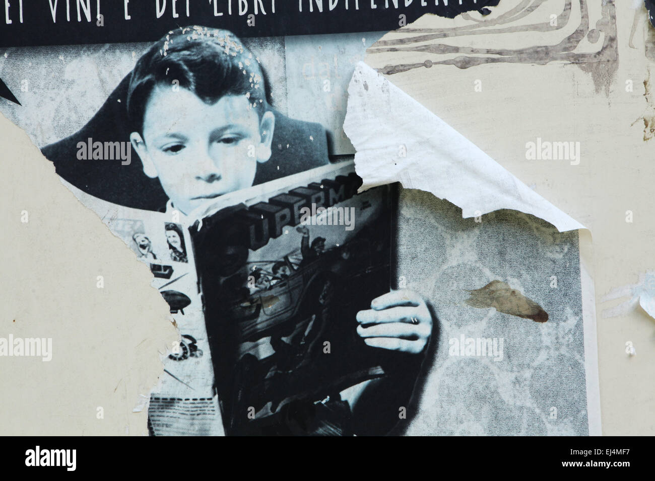Young boy reading a book in the old poster in Rome, Italy. Stock Photo