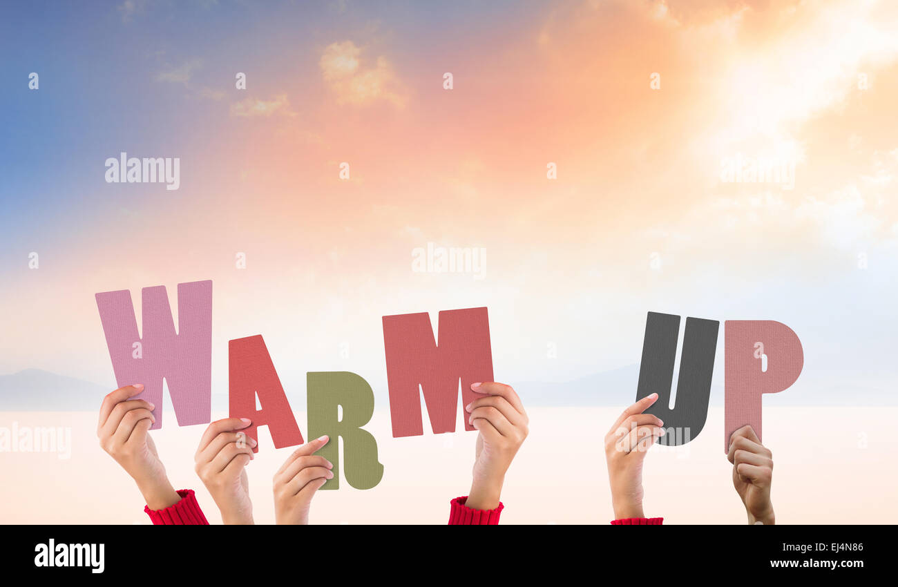 Composite image of hands holding up warm up Stock Photo