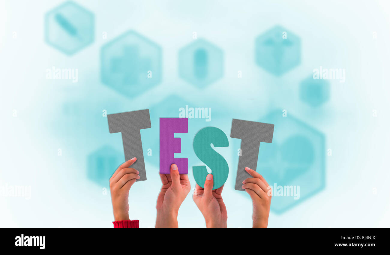 Composite image of hands holding up test Stock Photo - Alamy