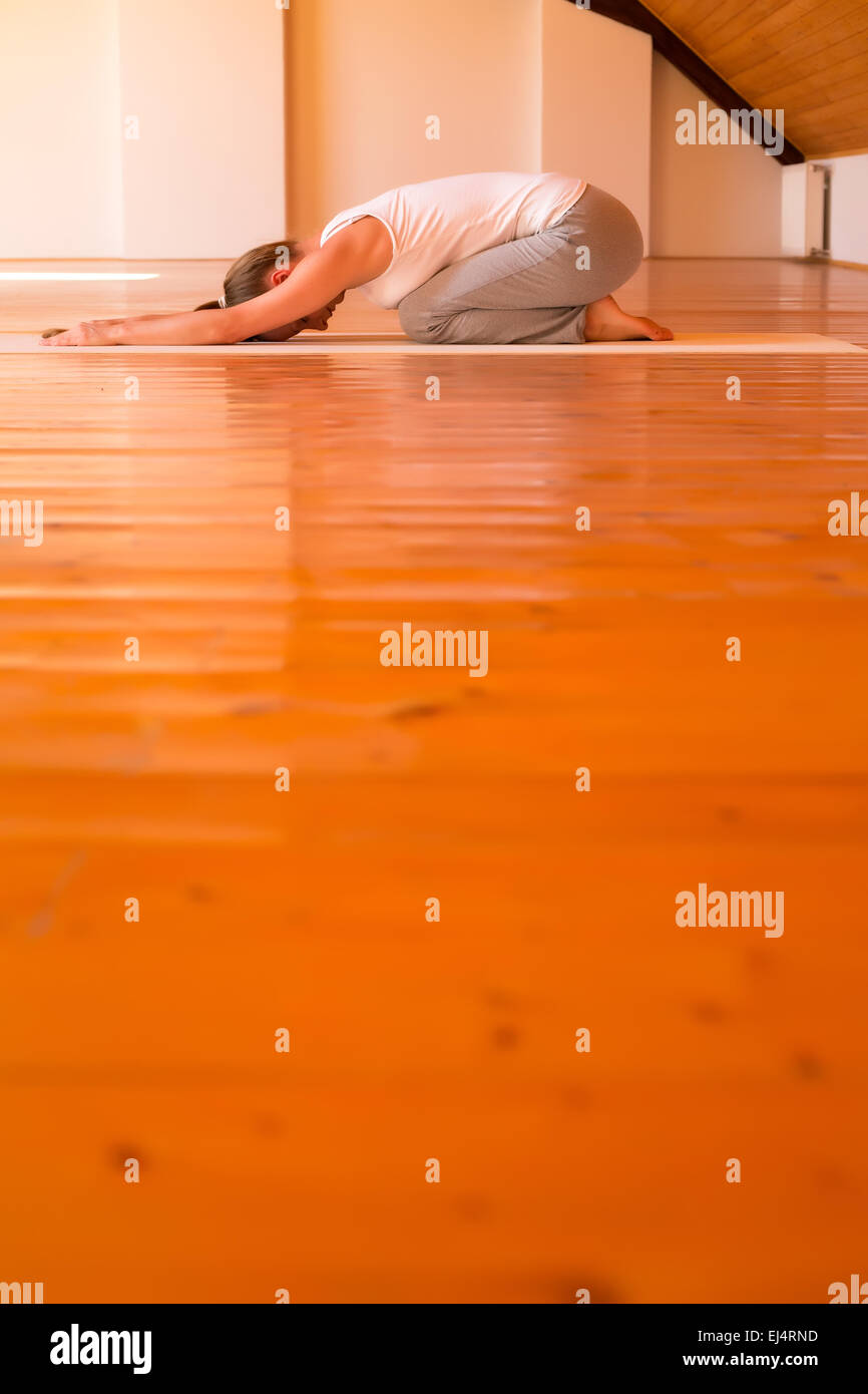 A young Woman practicing Yoga in a large attic Studio Stock Photo - Alamy