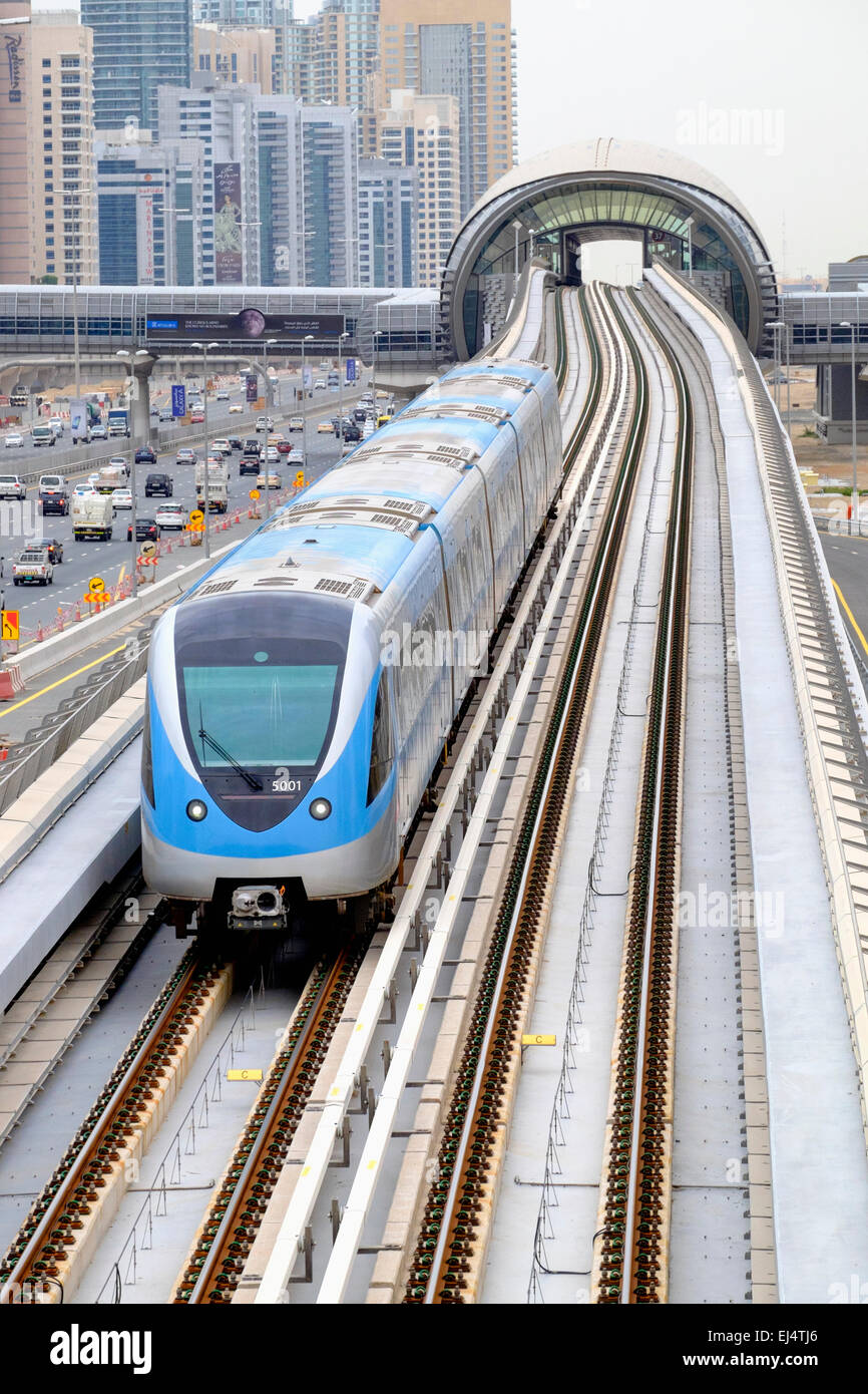 View of Dubai metro train on viaduct in Dubai United Arab Emirates Stock Photo