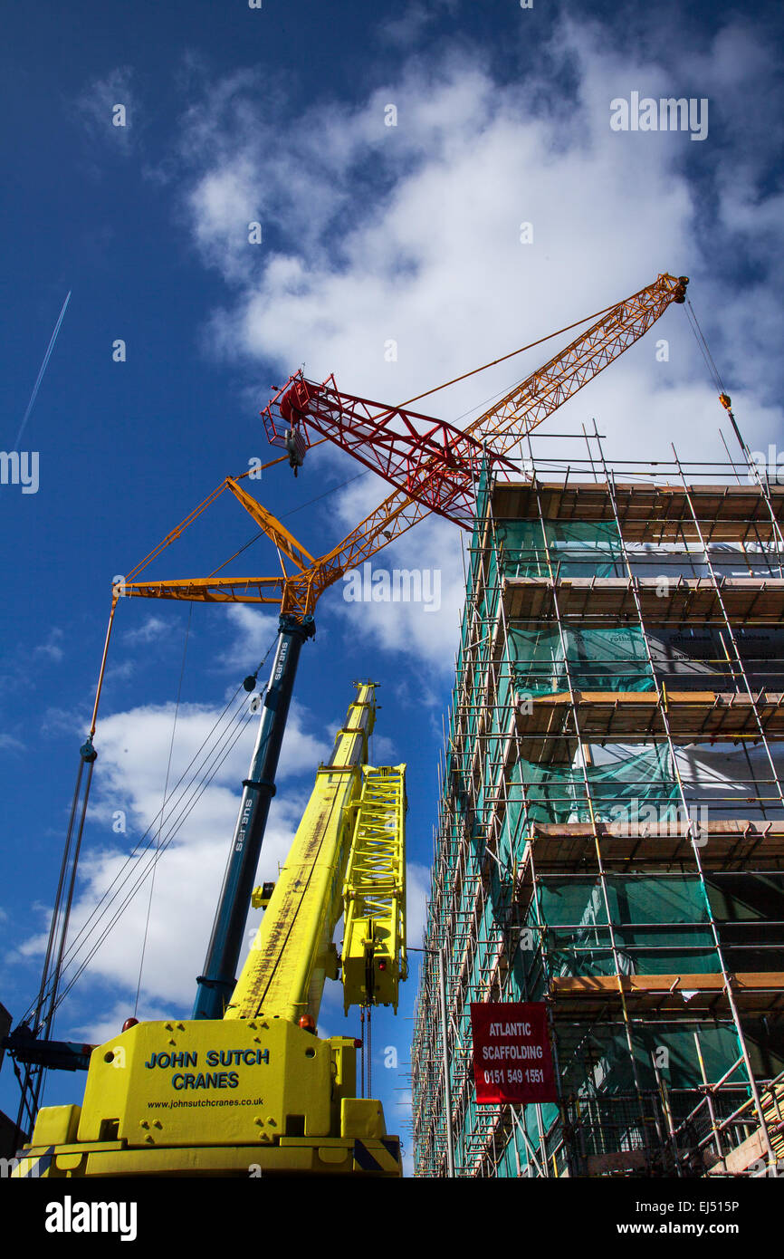 Student accommodation in Liverpool, Merseyside, UK 21st March, 2015.  40m-tall red Tower crane that has been used on the building site of a major complex built by Nordic Construction being removed.  The site at Hope Street is a student centre that will include 339 bedrooms, a gym, cinema, bars and restaurants. The crane is being dismantled with an even bigger 750 ton Luffer Crane with hydraulic luffing jibs, (used in tight urban work spaces when there is insufficient clearance for the jib to rotate), one of the biggest cranes of its type in Europe and one of only three in the UK. Stock Photo