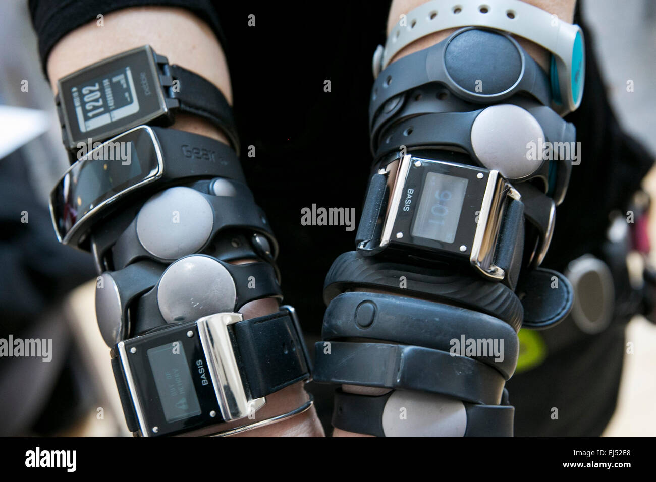 An individual is pictured wearing multiple wearable technology devices  including the Nike FuelBand, Fitbit, Basis, Pebble, Jawbo Stock Photo -  Alamy
