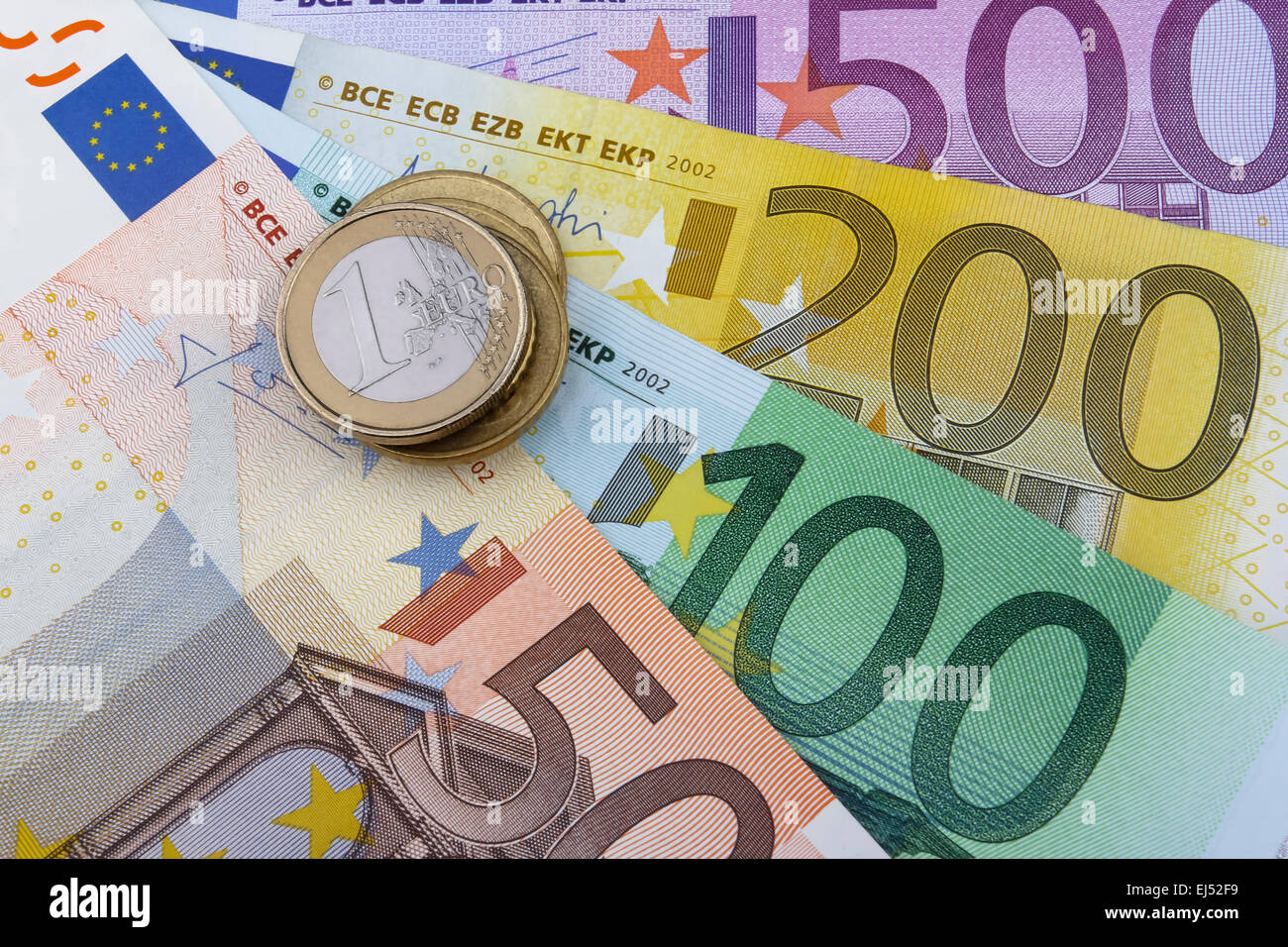 Euros (EUR) coins and notes. 50, 100, 200 and 500 Euro notes. 1 Euro coin on the left. Stock Photo