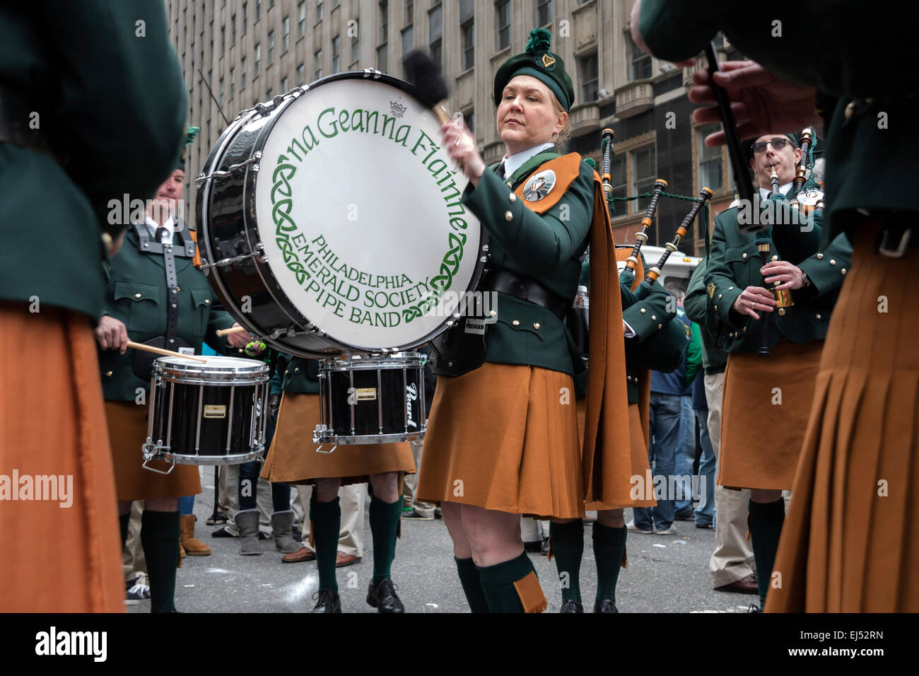 Woman  drummer of Philadelphia Emerald Society Pipe Band banging the drum, St. Patrick's Day Parade, Philadelphia, USA Stock Photo