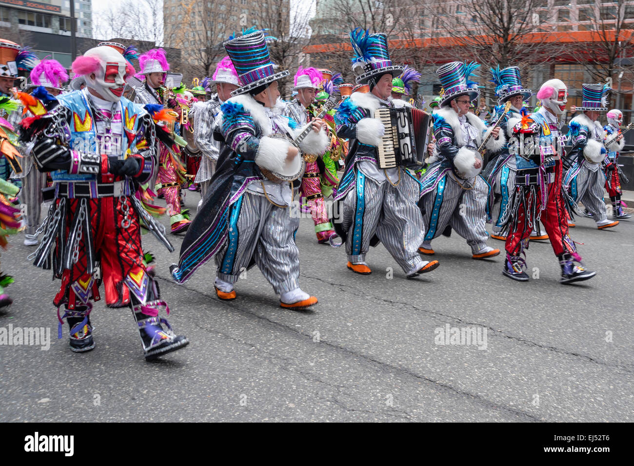 String band musicians playing and marching in colorful carnival costumes,  St. Patrick's Day Parade, Philadelphia, PA, USA Stock Photo