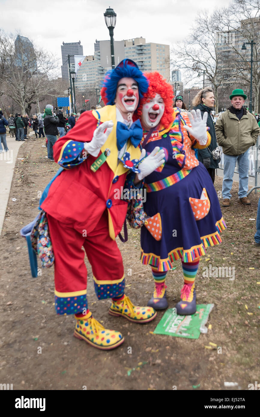 Two funny clowns amuse children on the streets,  St. Patrick's Day Parade, Philadelphia, USA Stock Photo