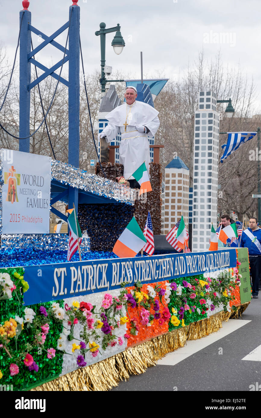 Catholic priest welcomes people with bright colored platform, St. Patrick's Day Parade, Philadelphia, USA Stock Photo