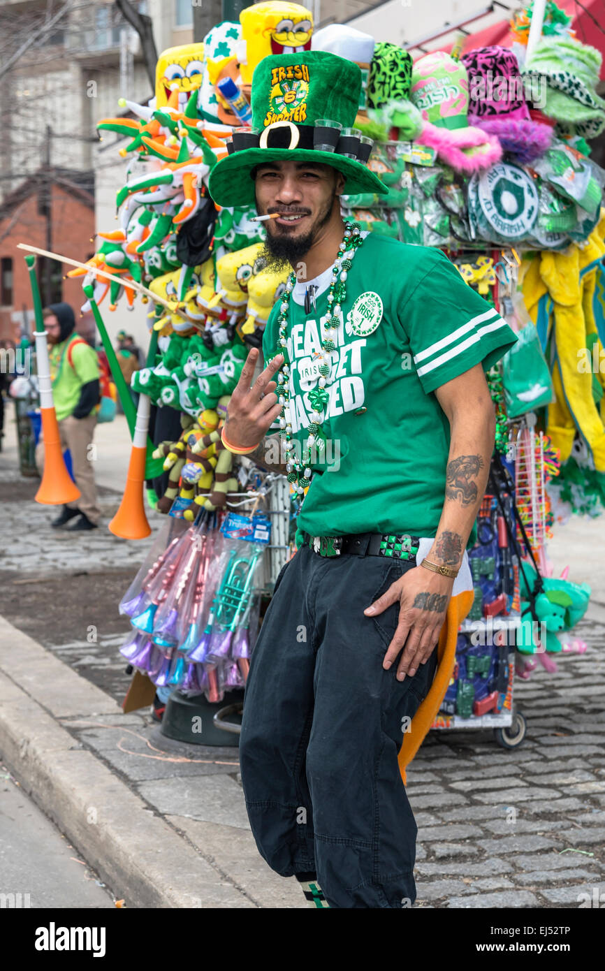 Smiling  seller Party Supplies and souvenirs,showing  victory sign , St. Patrick's Day Parade, Philadelphia, USA Stock Photo