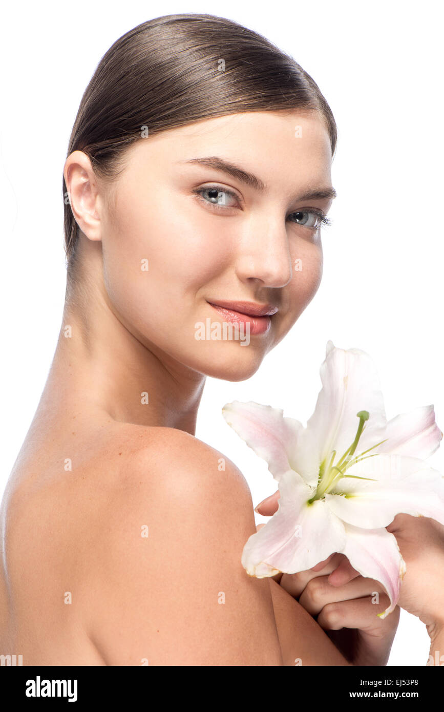 Beautiful face of the young woman with white flower Stock Photo