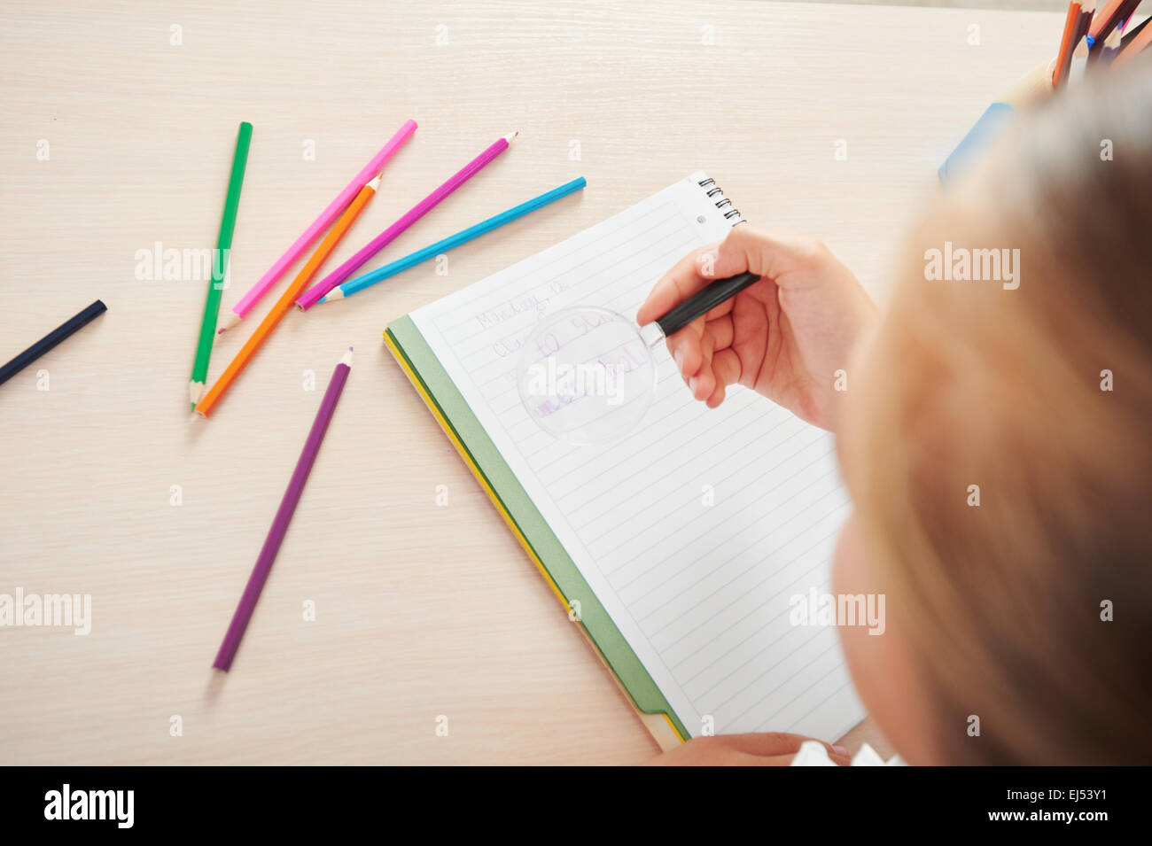 School girl writing in her notebook Stock Photo