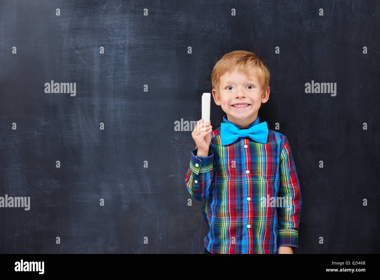 Boy with red hair looking forward far classwork Stock Photo