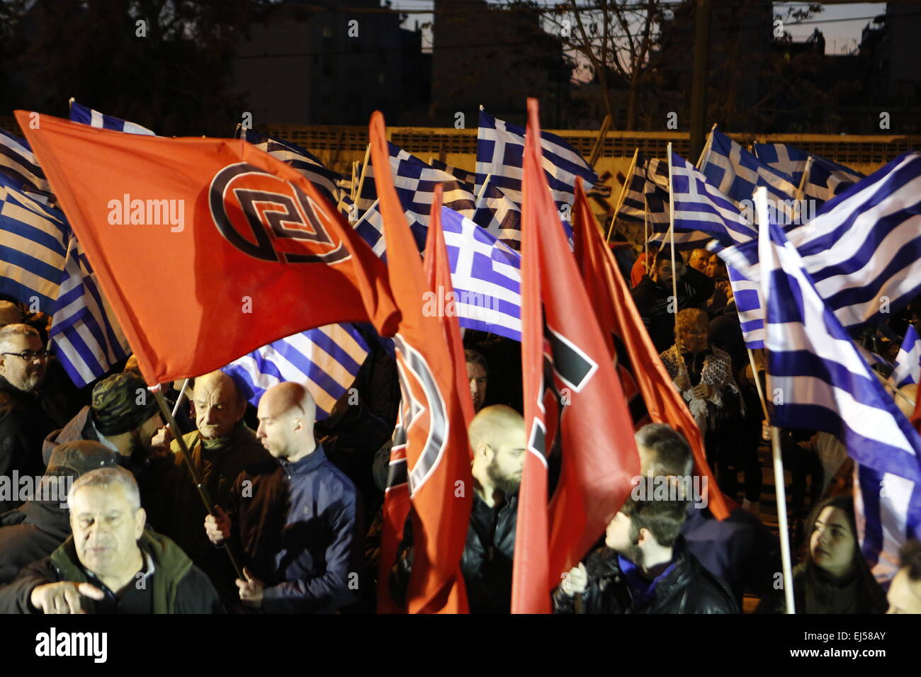 Athens, Greece. 21st March 2015. Greek and Golden Dawn flags fly at the Golden Dawn rally. Greek right wing party  Golden Dawn held an anti immigration rally on the International Day against Racism in Athens. Credit:  Michael Debets/Alamy Live News Stock Photo