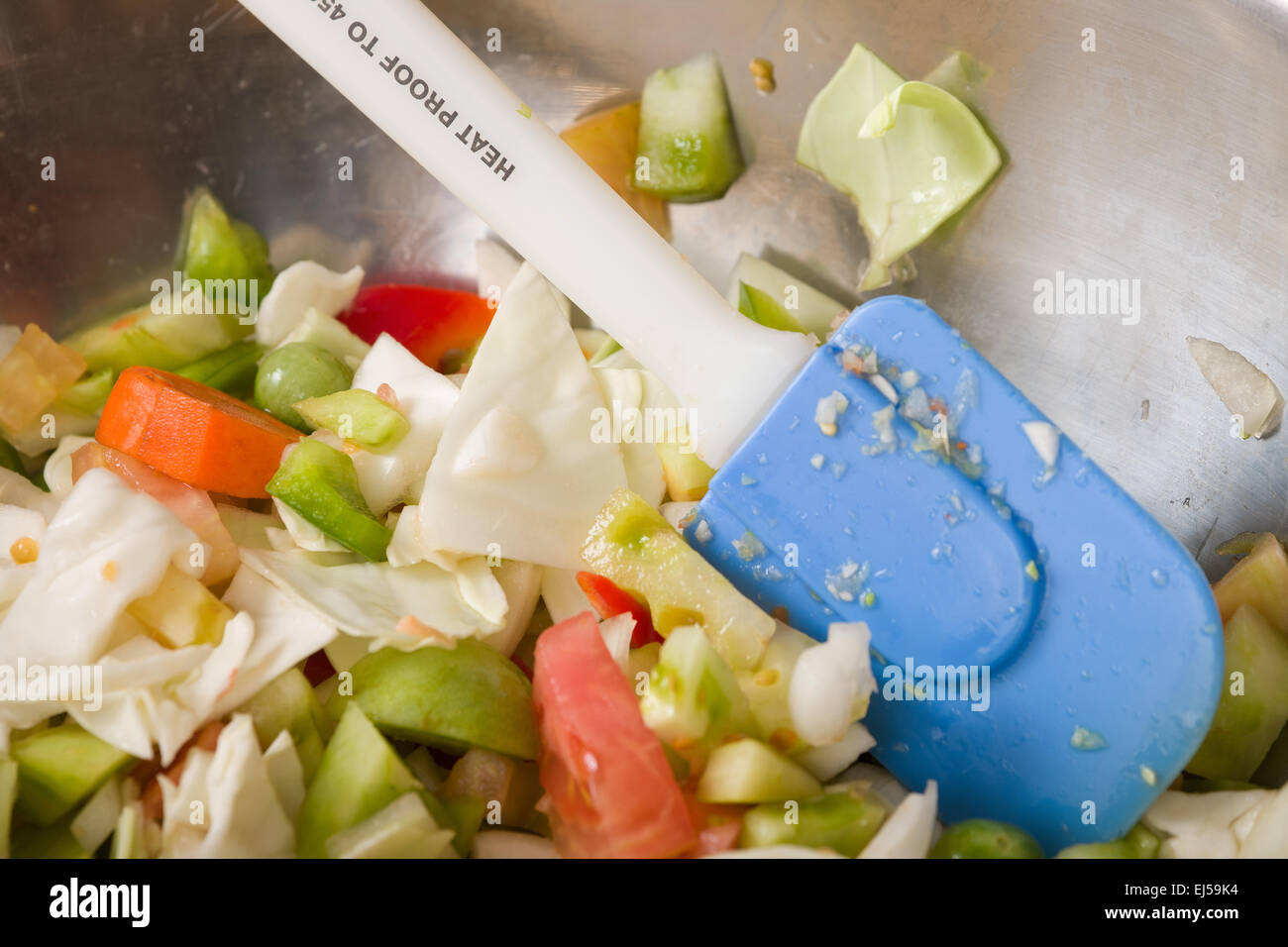 Metal bowl of chopped raw ingredients (bell peppers, onions, cabbage