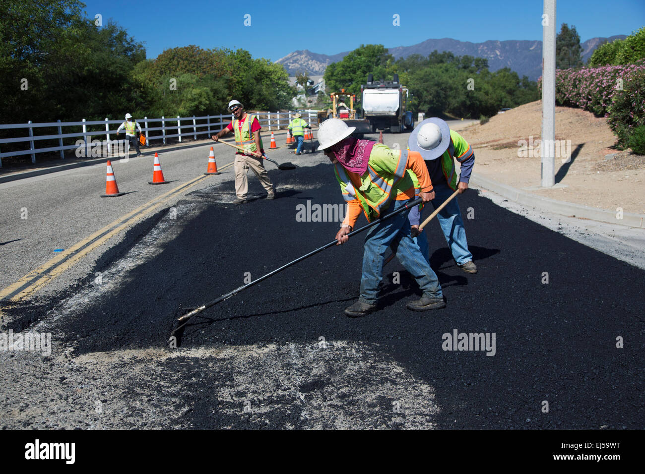 Roadworkers repaves road with steam, Encino Drive, Oak View, California, USA Stock Photo