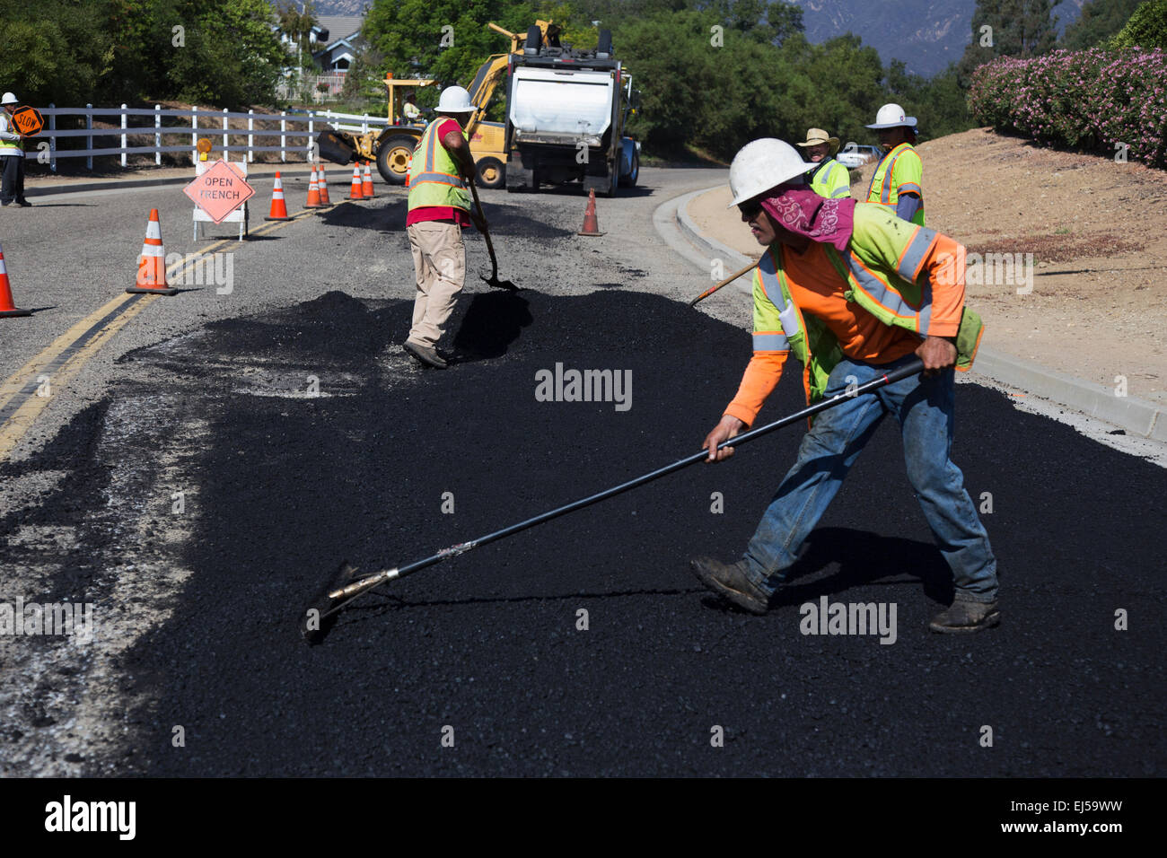 Roadworkers repaves road with steam, Encino Drive, Oak View, California, USA Stock Photo