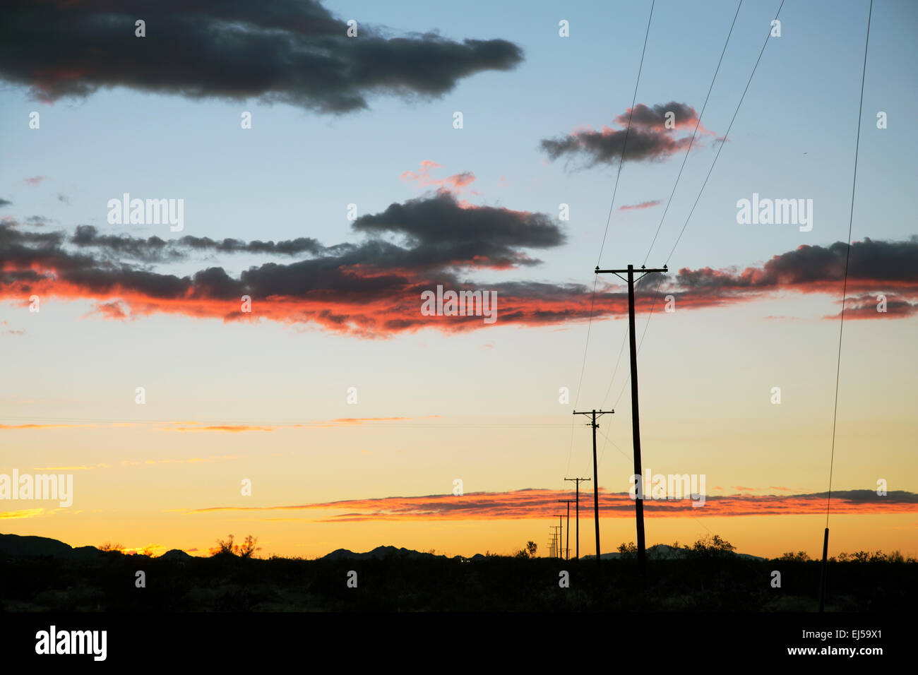 Telephone polls at sunset, Interstate 10, near Palm Springs, California, USA Stock Photo