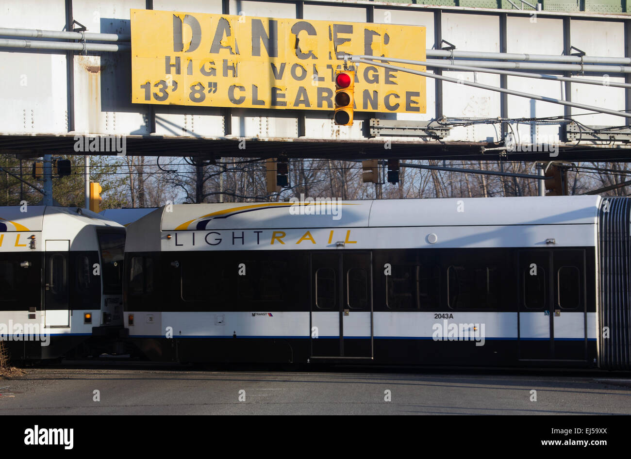 Sign saying 'Danger High Voltage' and NJ Light Rail Transit, Jersey City, New Jersey, USA Stock Photo