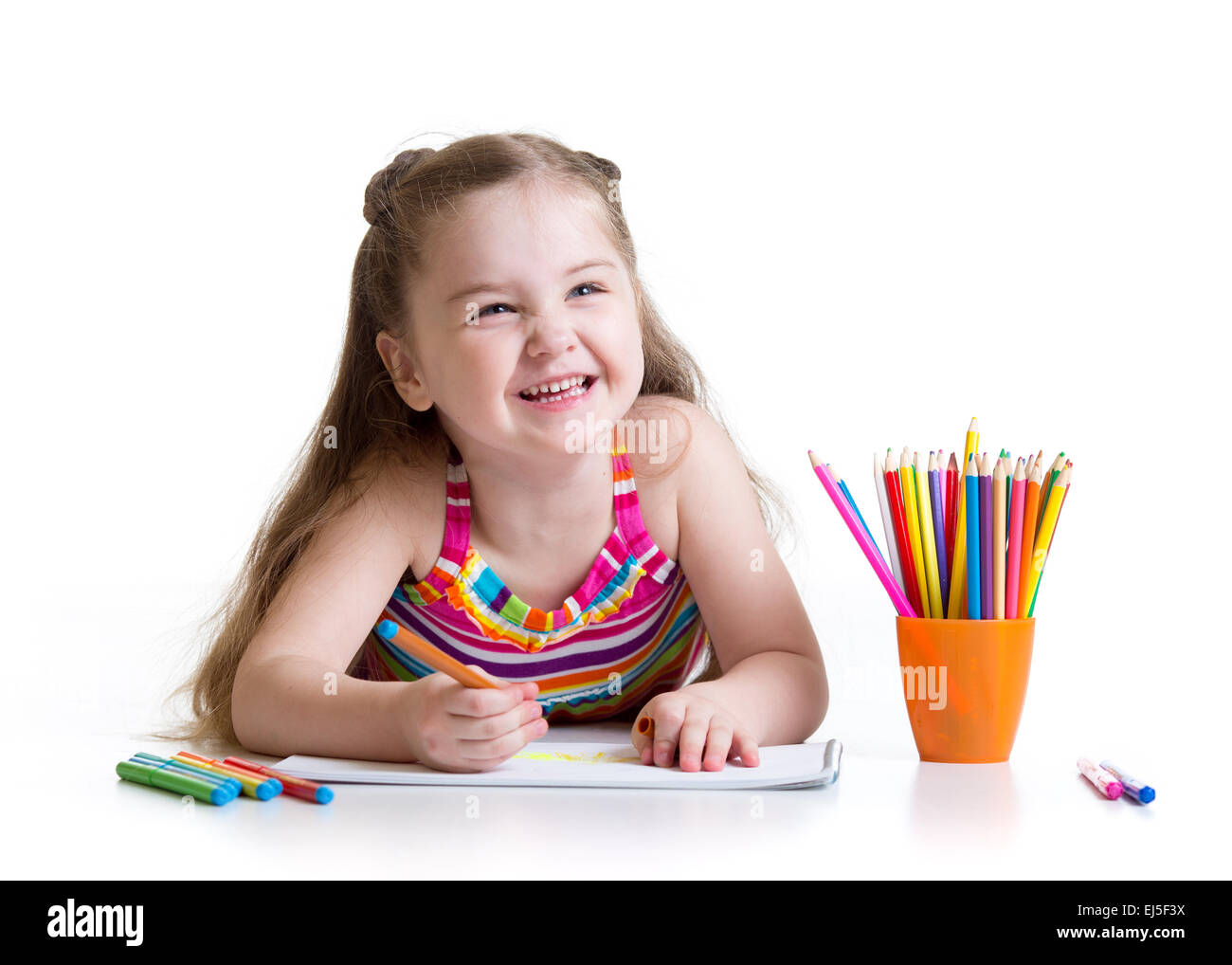 Happy little girl drawing with felt-tip pen in preschool Stock Photo