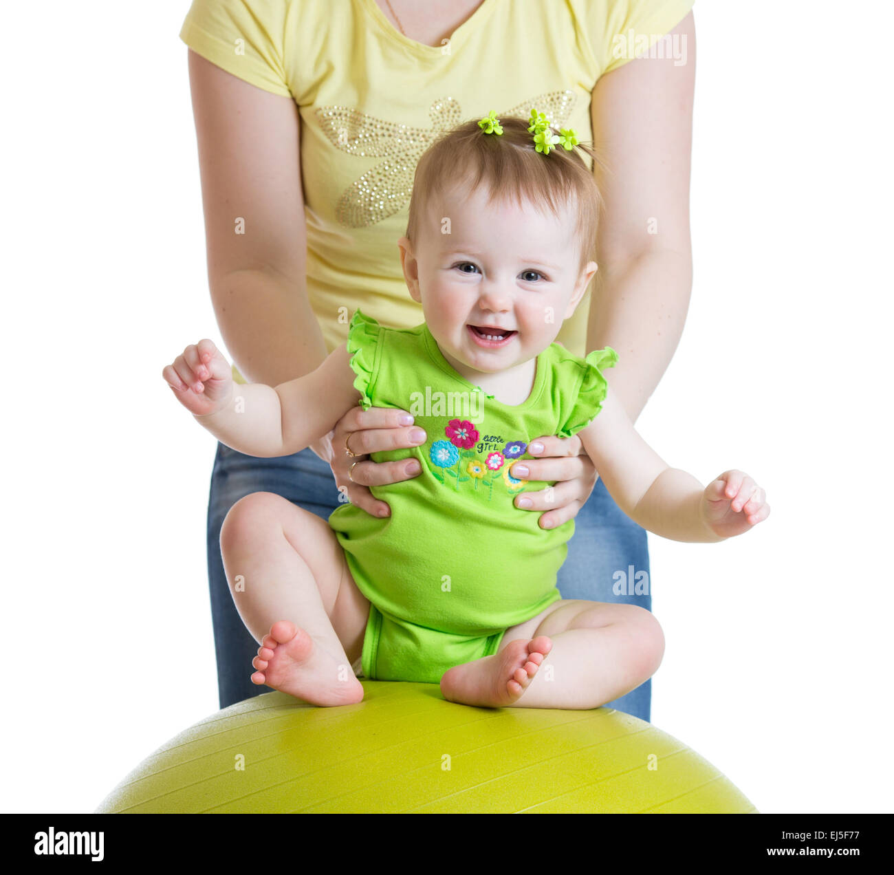 mother playing with baby on fit ball Stock Photo