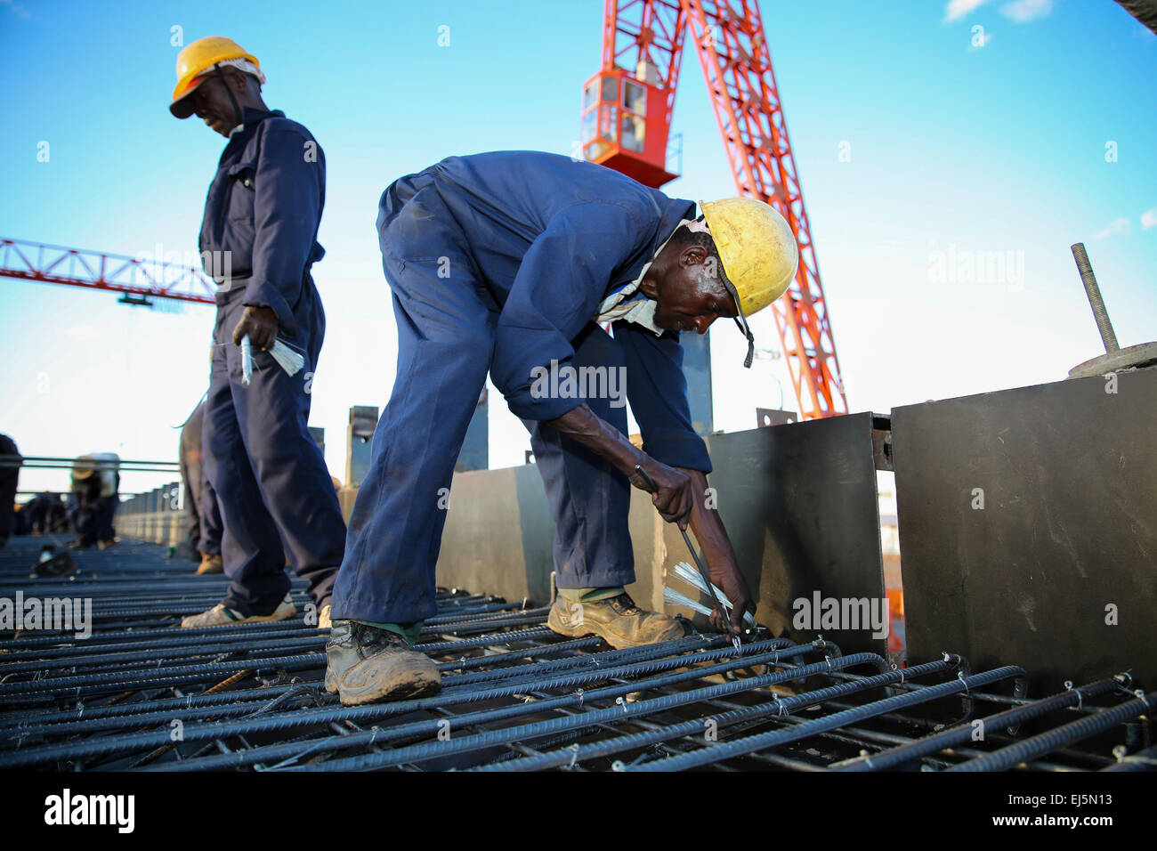 Nairobi, Kenya. 16th Mar, 2015. Workers work on a construction site on