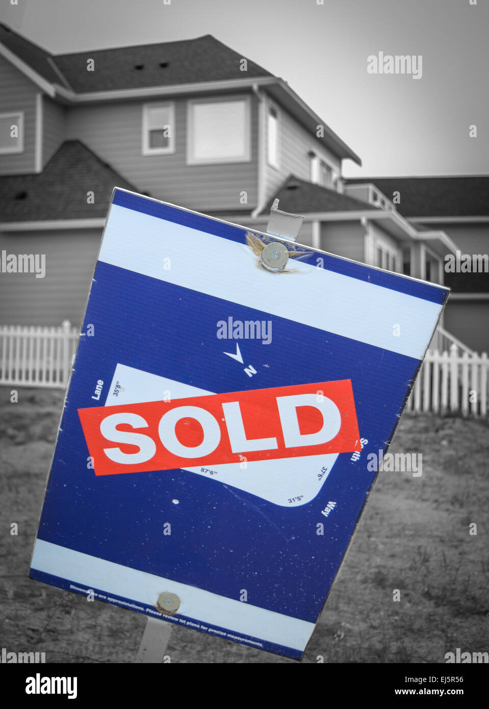 Real Estate Image Of A Sold Sign Beside A New Built Home Stock Photo