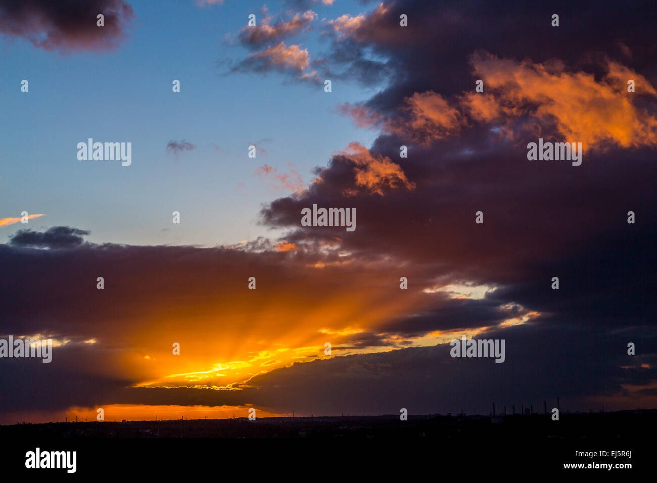 Dramatic sunset, dark clouds Stock Photo