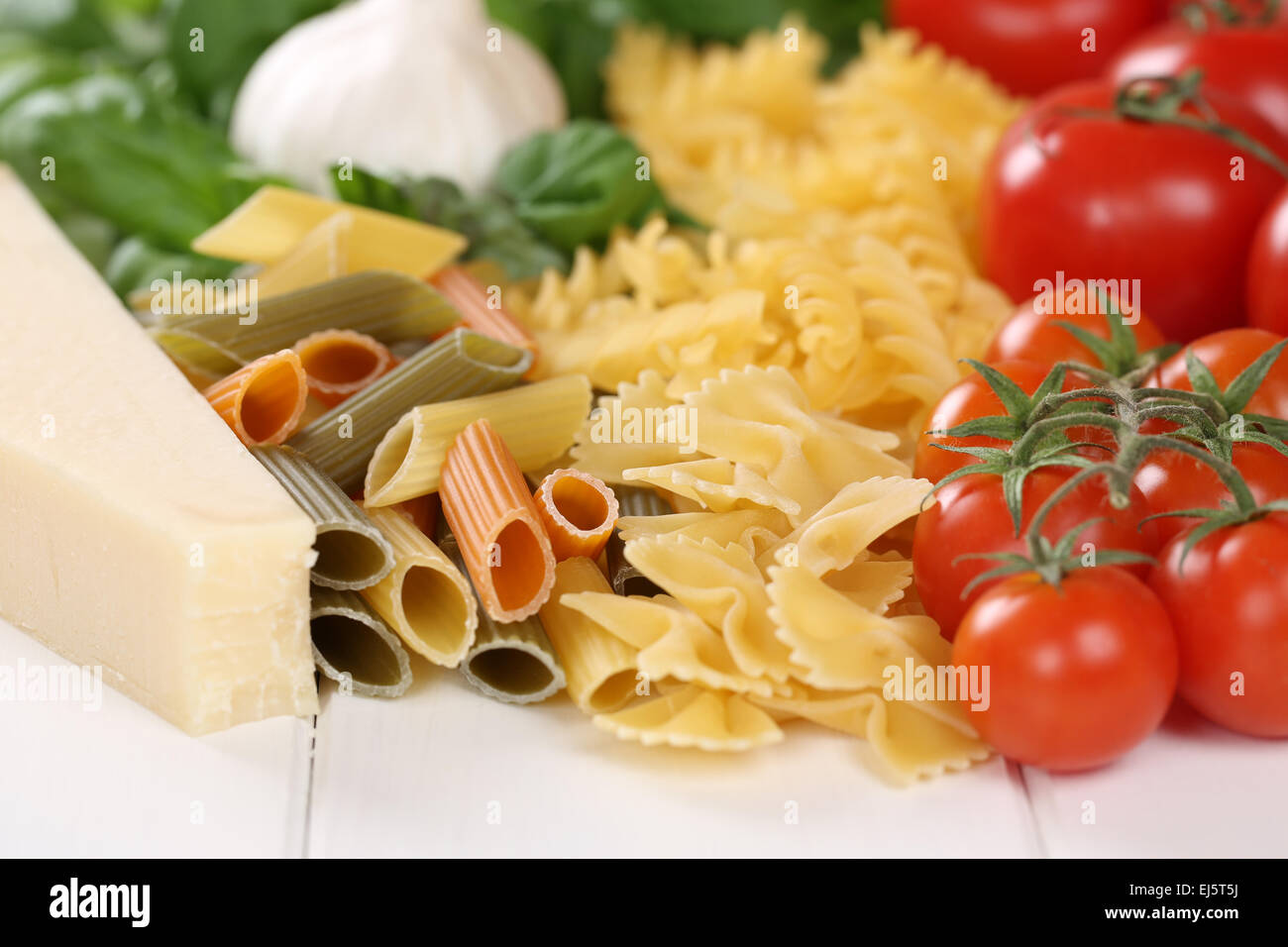 Ingredients for a Pasta noodles meal with tomatoes, penne, basil and
