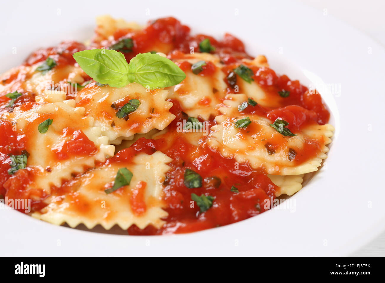 Italian Pasta Ravioli with tomato sauce meal with basil on a plate ...