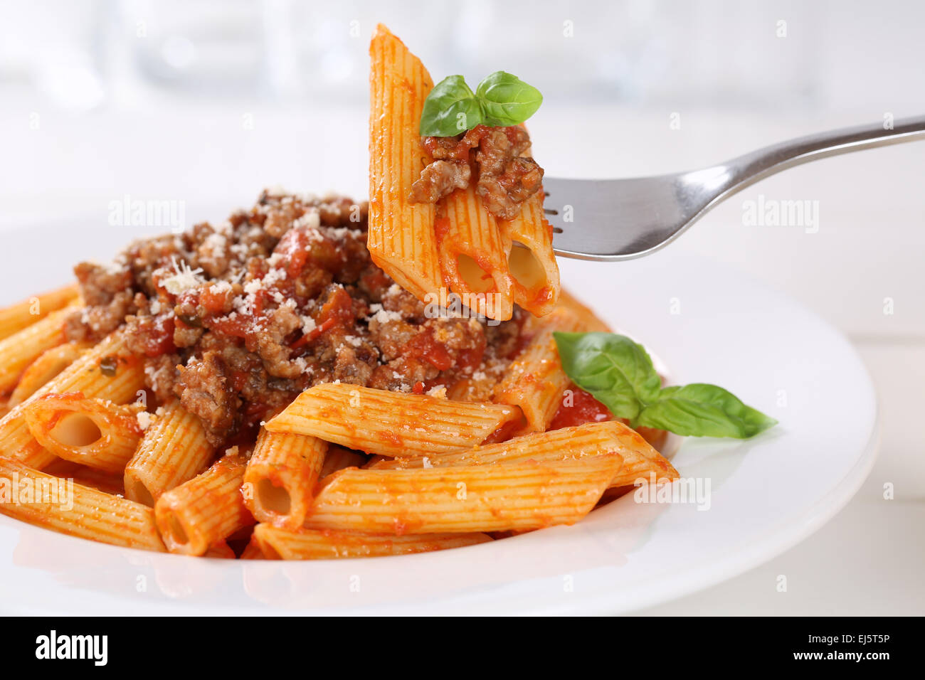 Eating Penne Rigate Bolognese or Bolognaise sauce noodles pasta meal on a  plate Stock Photo - Alamy