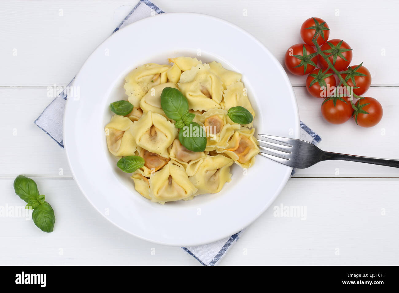 Italian Pasta Tortellini noodles meal with basil from above Stock Photo