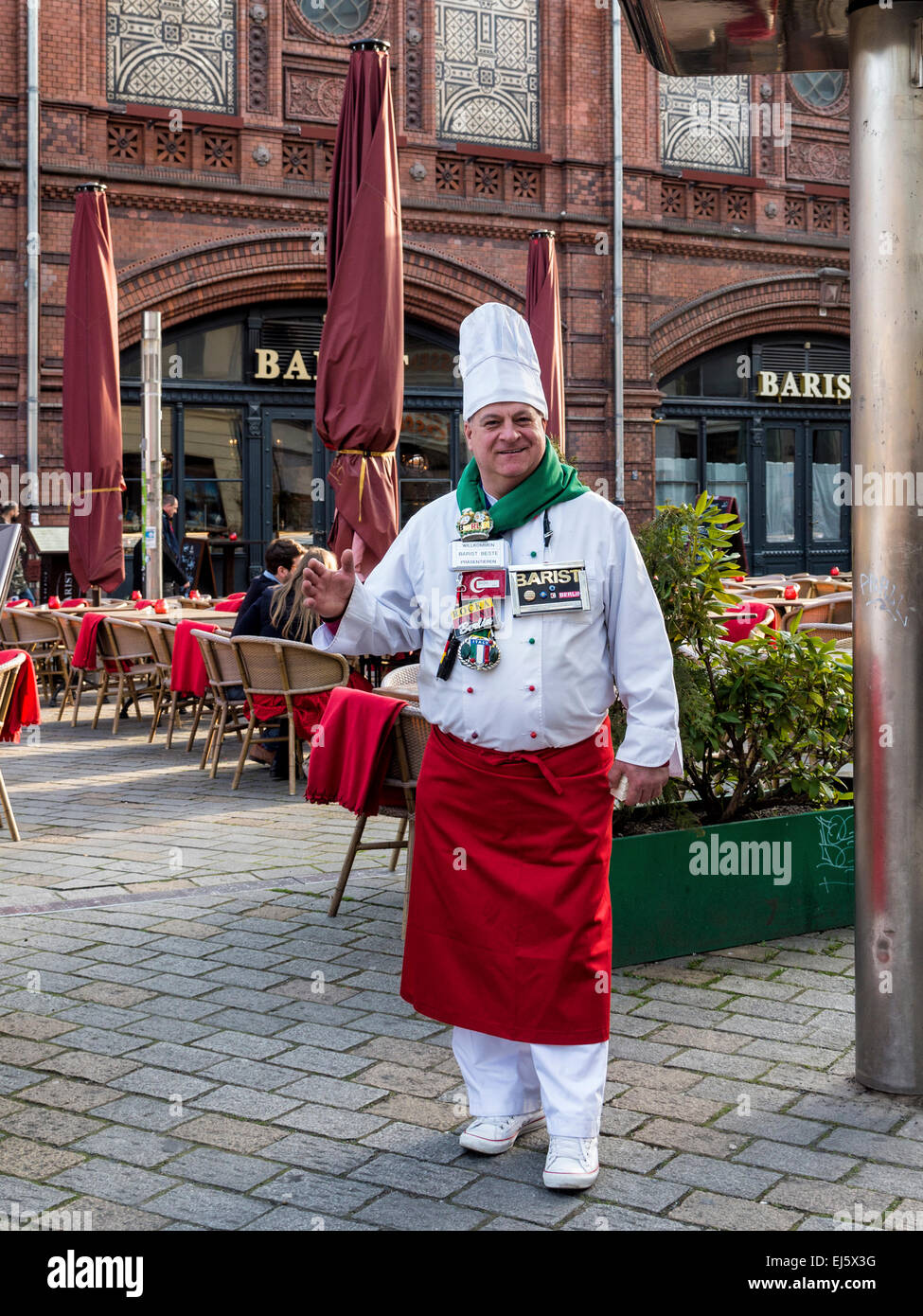 Chef welcomes diners outside Barist restaurant at Hackescher Markt, Mitte, Berlin Stock Photo