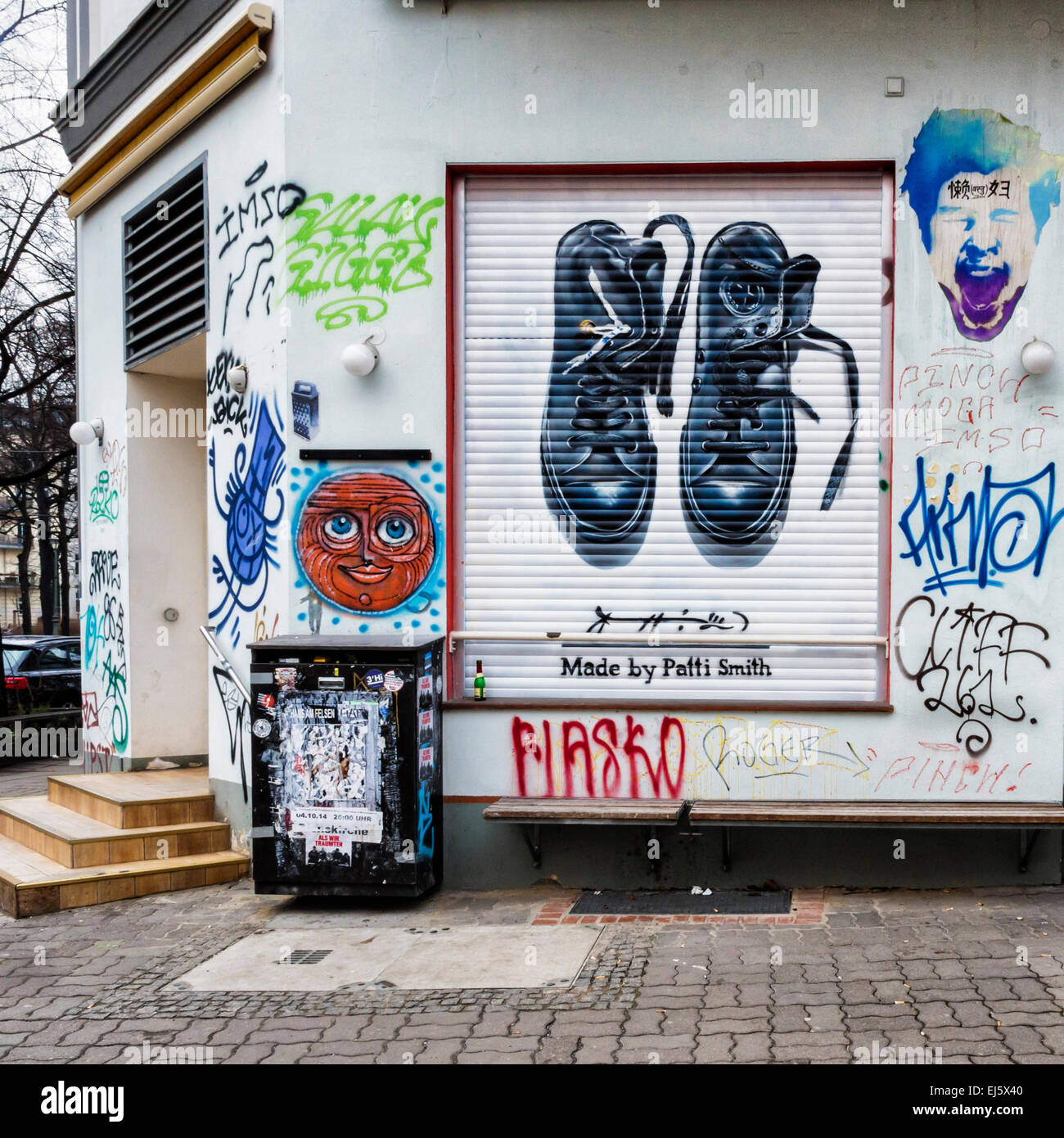 Advertisement for Converse trainers, chucks named after Chuck Taylor  amongst graffiti on shop blind, Mitte Berlin Stock Photo - Alamy