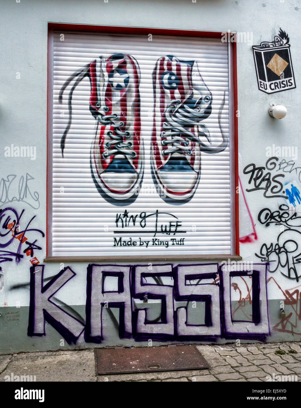 Advertisement for Converse trainers, chucks named after Chuck Taylor  amongst graffiti on shop blind, Mitte Berlin Stock Photo - Alamy