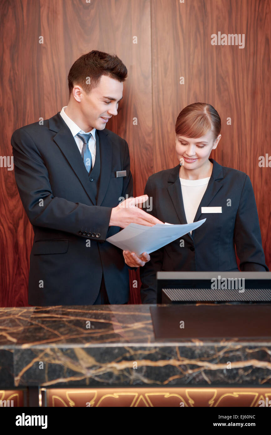 Hotel receptionists behind the counter Stock Photo Alamy