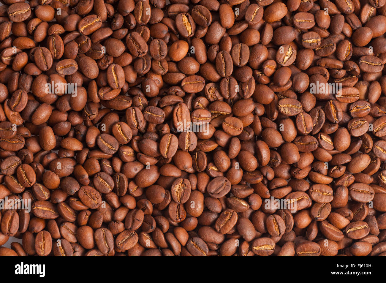 Roasted brown coffee beans make nice background Stock Photo - Alamy