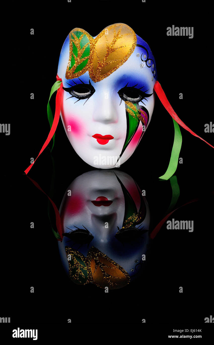 Emotional Mask on the black reflecting background Stock Photo - Alamy