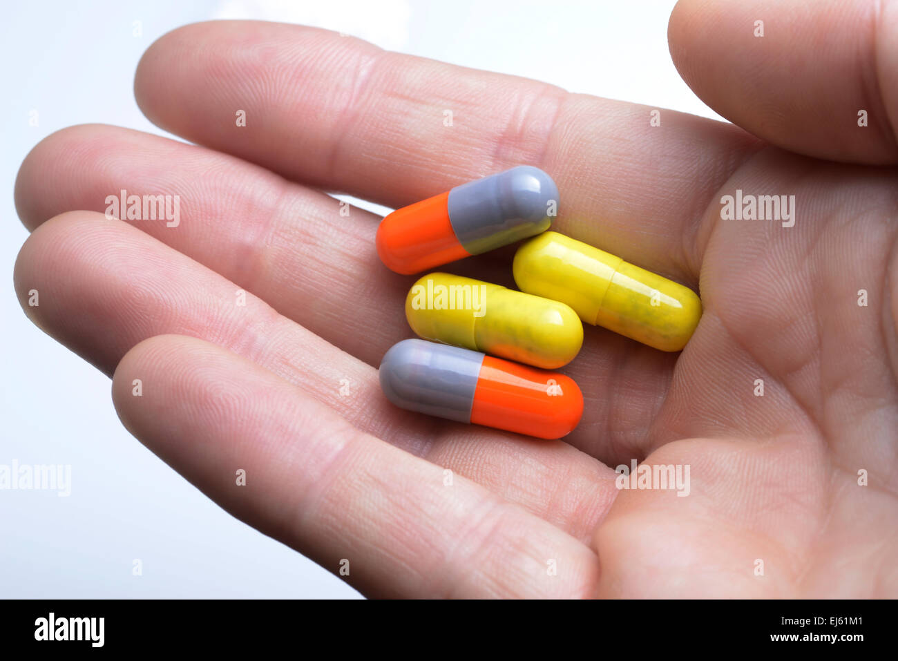 Legal highs, capsules in hand Stock Photo