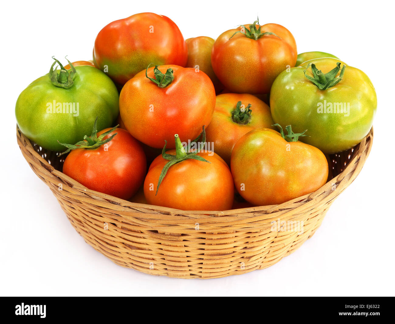 Some tomatoes in a basket over white background Stock Photo - Alamy