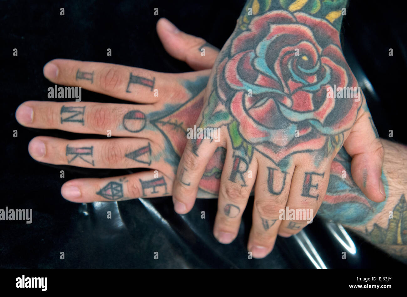 'True love' can be read on the hands of a tattooed man at the International Tattoo Convention in Frankfurt am Main, Germany, 21 March 2015. Tattoo artists from around the world show off their talents at various booths. Visitors can get their desired images tattooed on site. Photo: BORIS ROESSLER/dpa Stock Photo