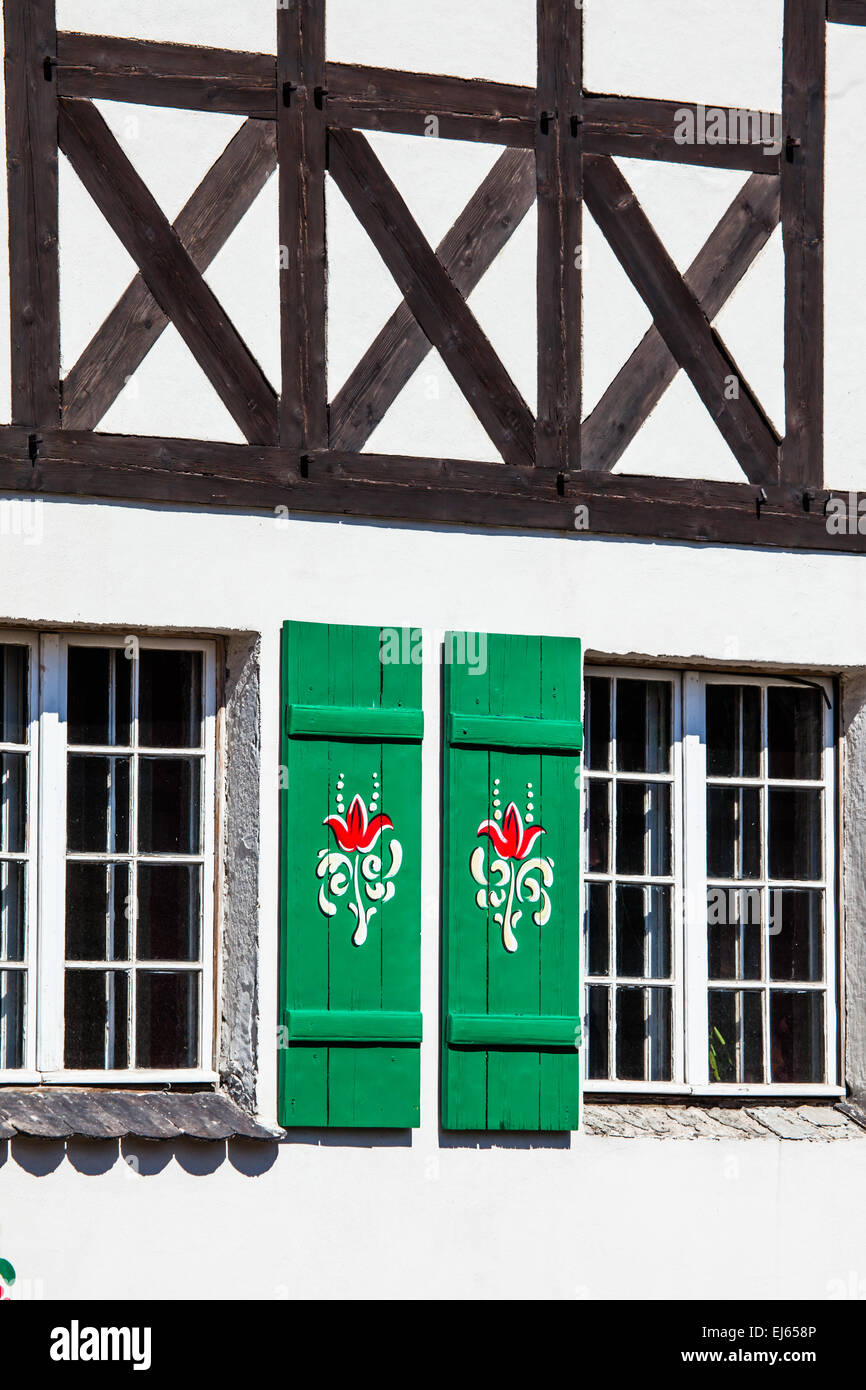 Typical germany windows with green shutters and window box Stock Photo