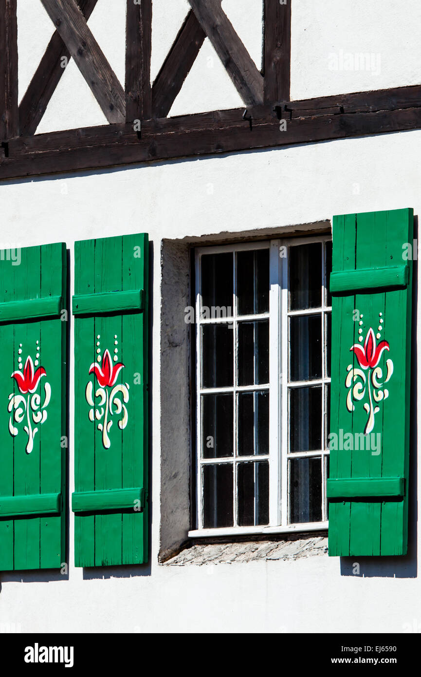 Typical germany windows with green shutters and window box Stock Photo