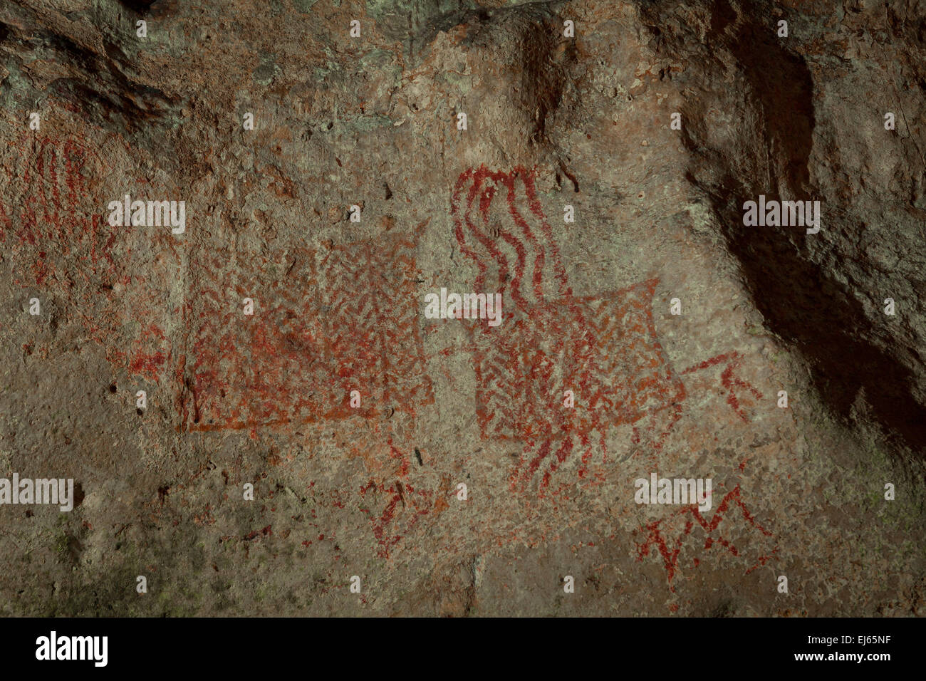 Ancient cave painting at prehistoric burial site of Gua Harimau (literally: tiger cave) in Padangbindu, Ogan Komering Ulu, South Sumatra, Indonesia. Stock Photo