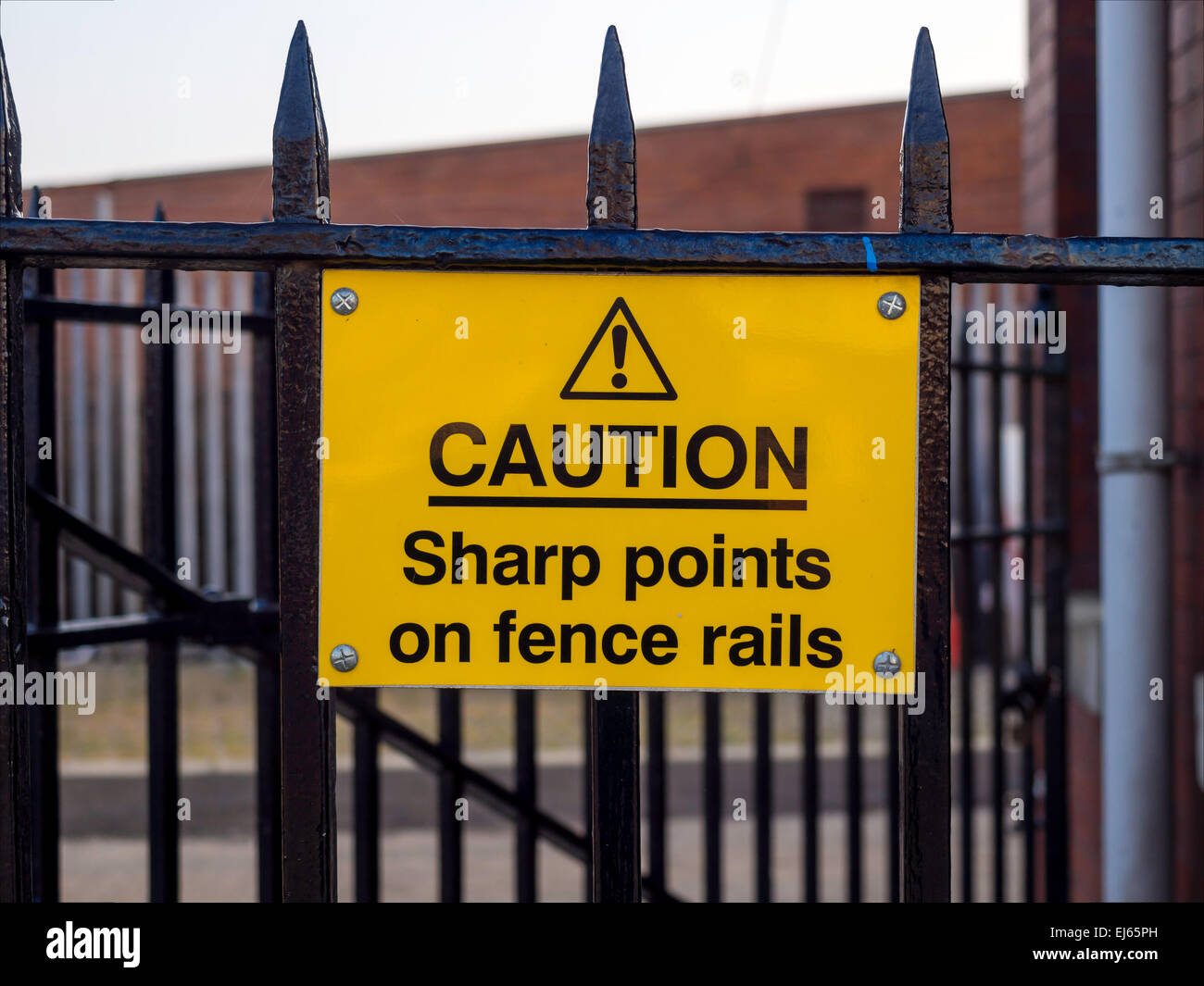 Sign reading Caution Sharp Points on Fence rails to deter climbers ...