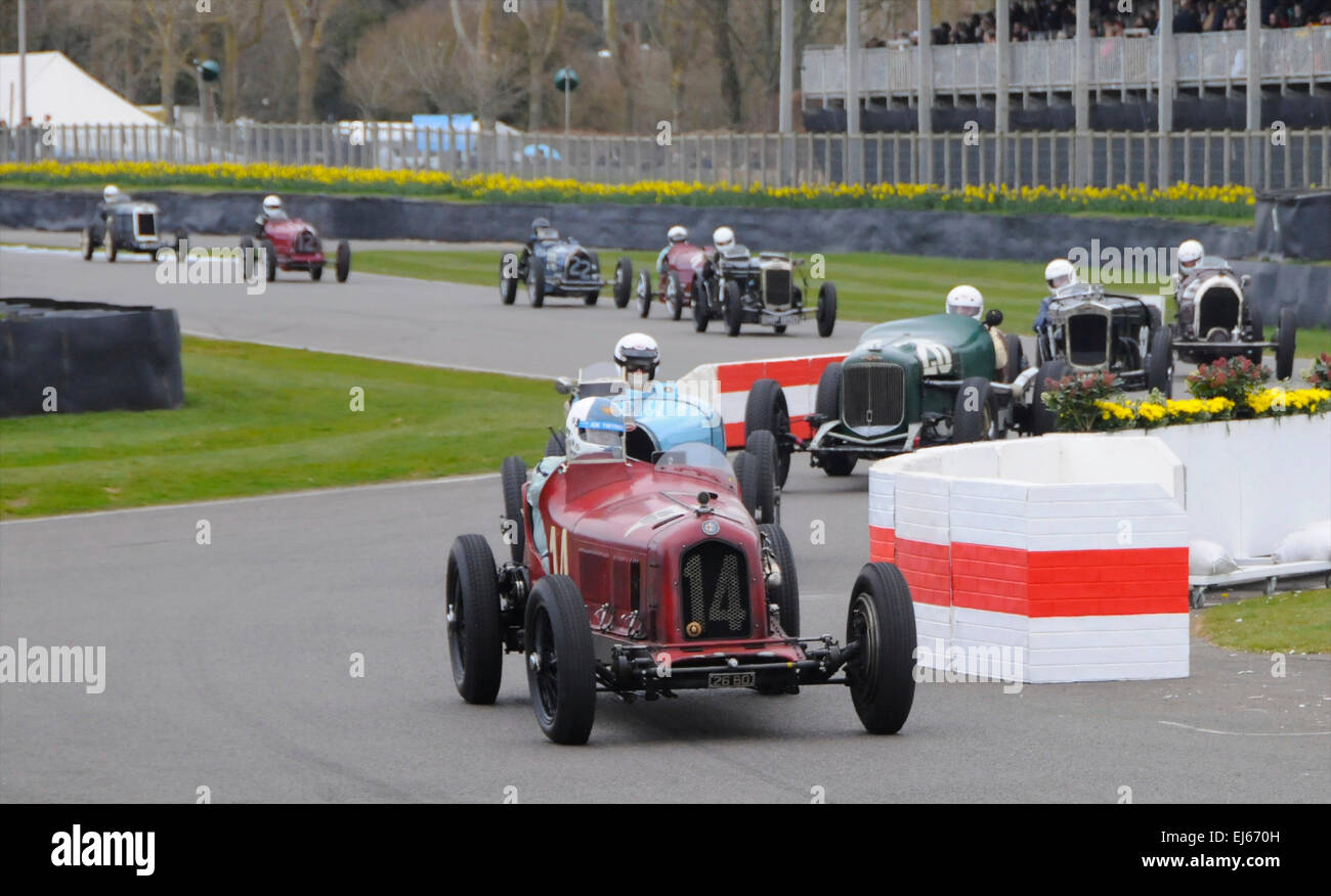 Among the literally millions of pounds worth of motoring legends going through their paces at the 73rd Goodwood Member's Meeting held on 21st and 22nd March 2015 in Sussex were a fine collection of vintage Bugattis and others, here following an Alfa Romeo 8C-2600 built in 1932 through the chicane at Goodwood. Stock Photo