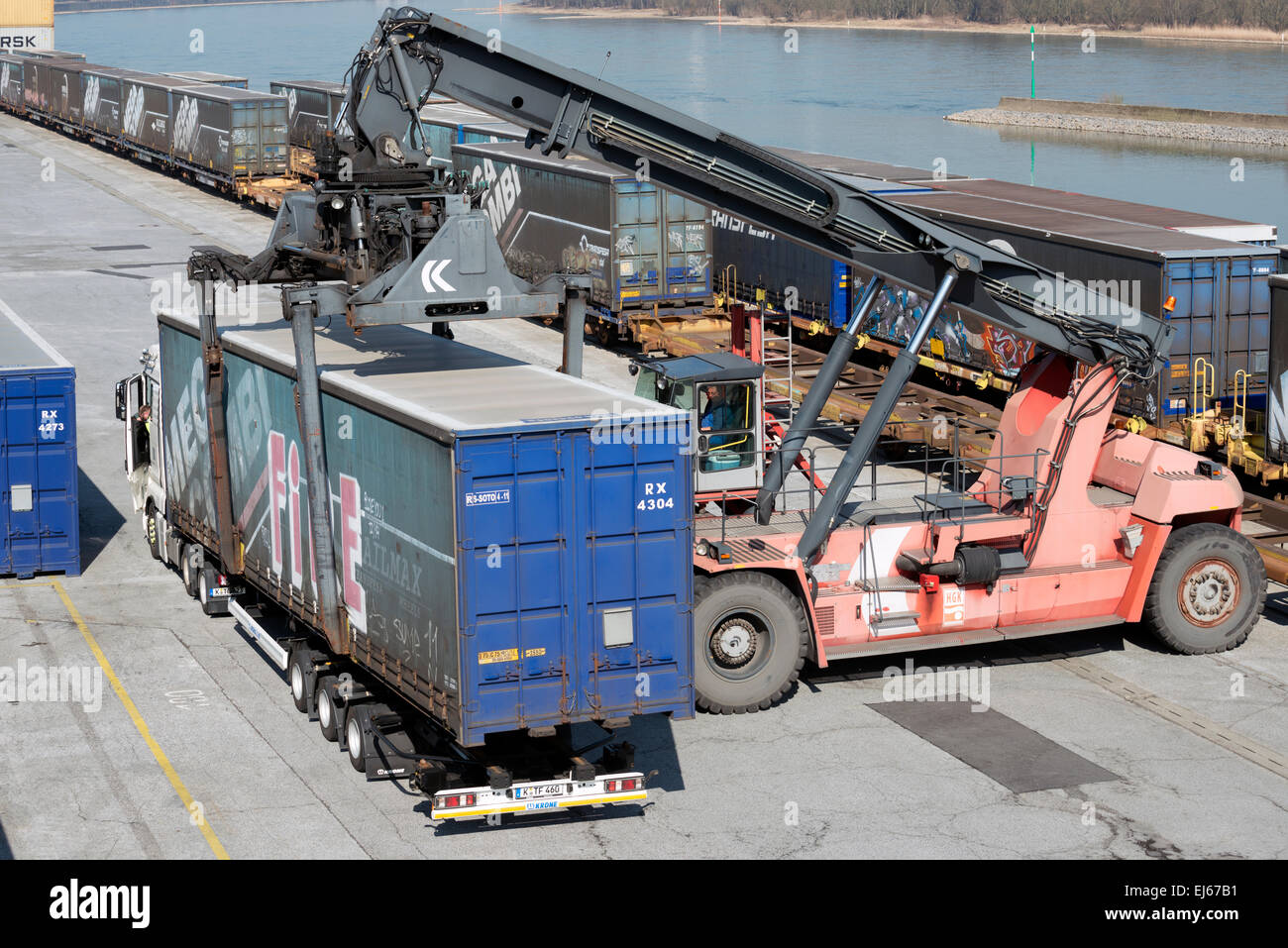 Container being loaded onto lorry by self-propelled loader at Niehl 1 container terminal, Cologne, Germany. Stock Photo