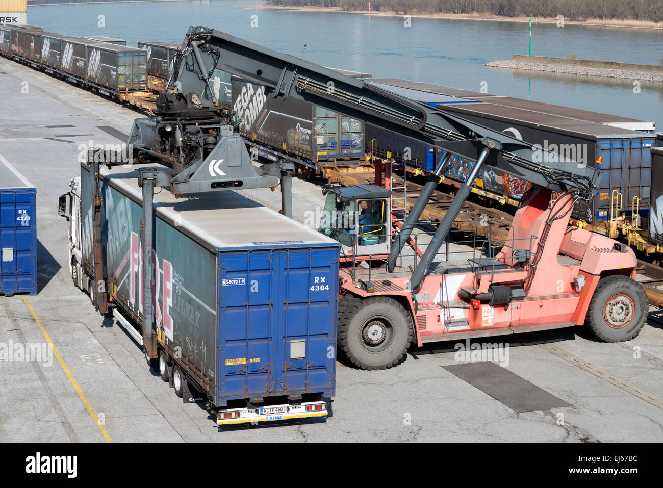 Container being loaded onto lorry by self-propelled loader at Niehl 1 container terminal, Cologne, Germany. Stock Photo