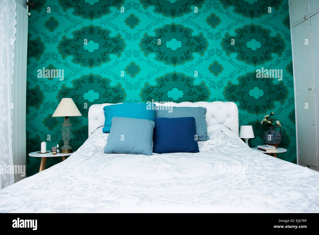 Bedroom design with colorful wallpaper and turquoise and white color