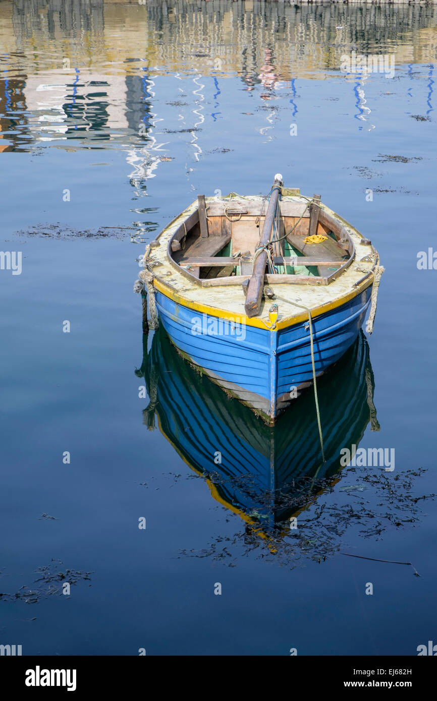 Old wooden dinghy moored in Falmouth harbour Cornwall England UK Stock